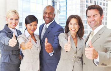 group of professionals smiling to the camera with thumbs up